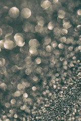 Festive abstract gray background with lights in defocus.
