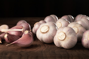 Garlic heads and cloves on wooden table