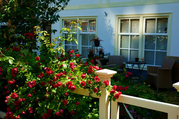 Old house window and patio with outdoor furniture