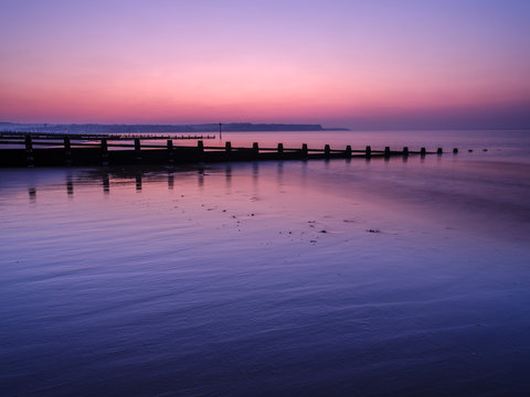 Early morning looking at Exmouth beyond the sea defences, Dawlish Warren, Devon