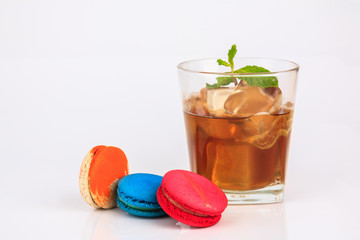 Colorful macarons cakes with and cup tea Isolated