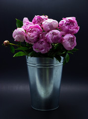 Pink peonies in a vase. Peonies pink background.