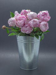 Pink peonies in a vase. Peonies pink background.