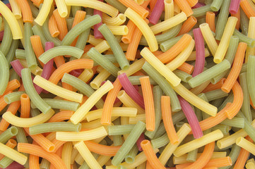 Uncooked colorful macaroni as background