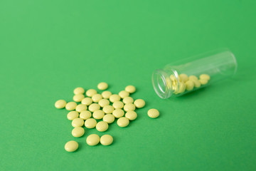medical pills on isolated green background, concept of life and health