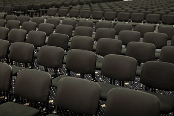 Black chairs in big empty congress room