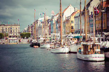 COPENHAGEN, DENMARK - JULY 02, 2019: Scenic summer view of Nyhavn pier with color buildings, ships, yachts and other boats in the Old Town of Copenhagen, Denmark.