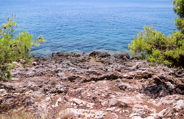 Sea coast and beach with rocks, rocky coastline, blue sea, good sunny day. Summer trip. Beautiful Greece. Most beautiful beach, natural environment, waves and tropical landscape, horizon and panorama.