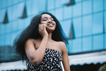 Shot of a young businesswoman talking on a cellphone in the city .