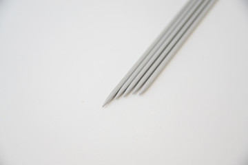 metal gray spokes on a white background, five pieces, hosiery spokes