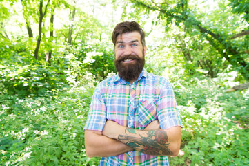 Naklejka na ściany i meble Emotional nature lover. Man bearded hipster green trees background. Guy relax in summer nature. Man handsome beard and mustache in summer forest. Summer vacation concept. United with environment