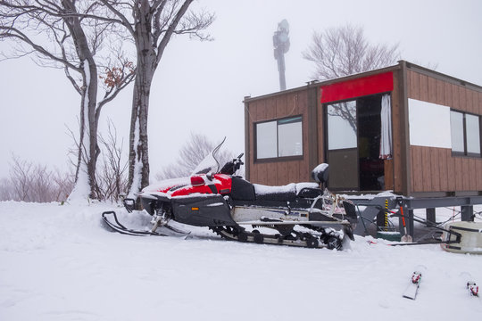 Snow mobile parked at the property, which is a ski area