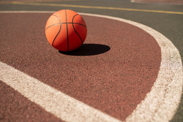 Ball for playing basketball lying on sports field or stadium