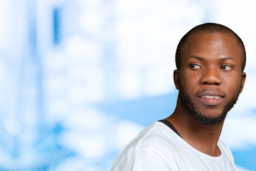 Obraz premium Portrait of stong and handsome african male student looking at camera smiling