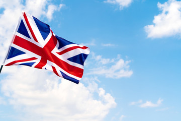 United Kingdom Flag waving on wind in blue sky