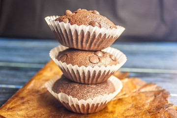 chocolate cupcakes with chocolate drops in rustic style