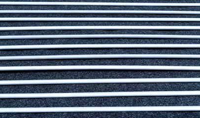 Close up view and low light. Black and white fabric sheet stacked in horizontal straight line.