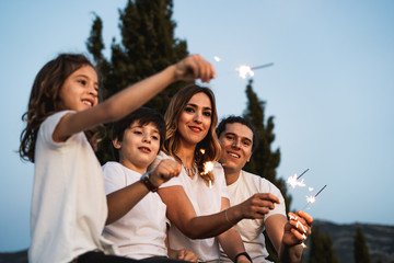 Family with happy sparklers