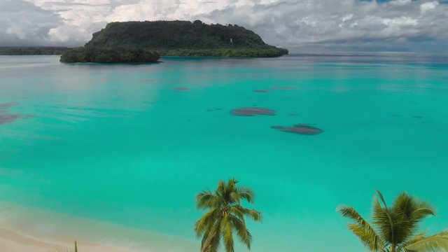 Port Orly sandy beach with palm trees, Espiritu Santo Island, Vanuatu.