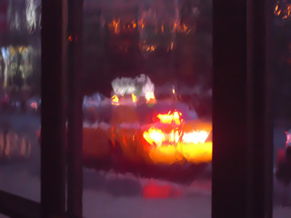 Yellow cab through rain streaked window