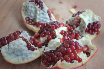 Sliced cropped garnet on a wooden board