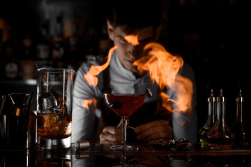 Close shot of bartender firing up a cocktail