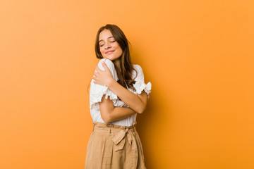 Young caucasian woman hugs, smiling carefree and happy.