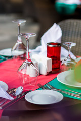 nicely decorated table appointments with beautiful decor with plates and serviettes. The elegant dinner table