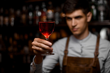 Close-up of alcohol cocktail in hand of bartender