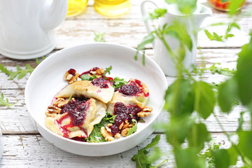 Fruit dumplings with fruit mousse and nuts.