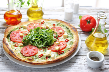 Pizza. Traditional Italian pizza on a thin crunchy dough with mozzarella, tomatoes, arugula.