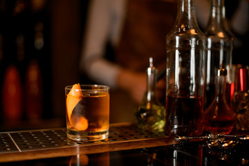Glass with a whiskey, ice and zest