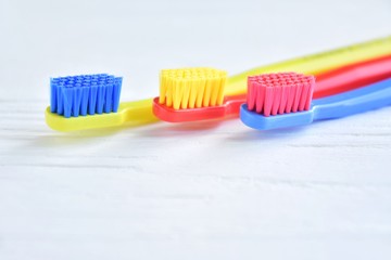 colorful toothbrushes in glass