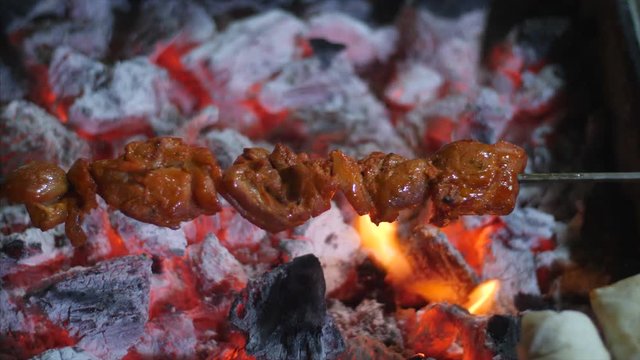 Seekh kebab being cooked over a very high flame in a coal furnace. 