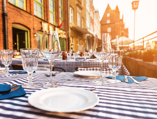 glasses and plates on the tables on sunset