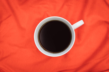 Coffee cup top view on minimal bright orange color background