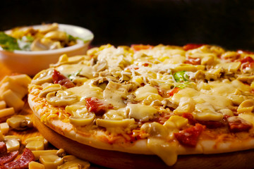 Freshly baked pizza with mushrooms, salami and cheese