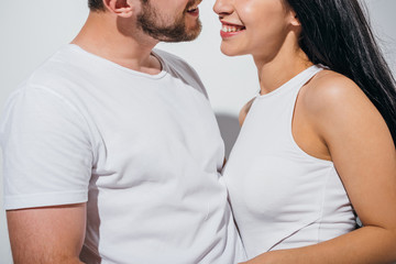 cropped view of couple in love smiling while standing close to each other