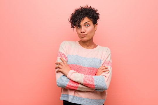 Young Mixed African American Teenager Woman Unhappy Looking In Camera With Sarcastic Expression.