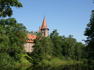 Fototapeta premium Cesvaine stone castle, beautiful summer day, pond, reflections, Latvia