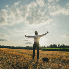 Successful young businessman standing in nature