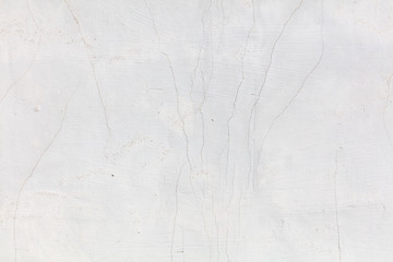 White wall with cracked plaster as abstract background