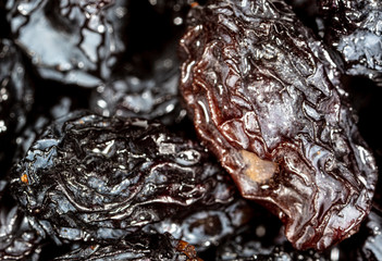 Black dry raisins as background