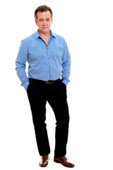 Fototapeta premium Business elderly man wearing formal clothes blue shirt and black pants posing on isolated background. The concept of business and positive pensioner. Advertising space