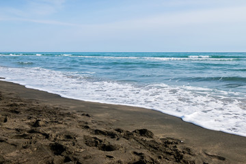 Beautiful sea and the black sandy beach, Tyrrhenian sea near Roma, Italy