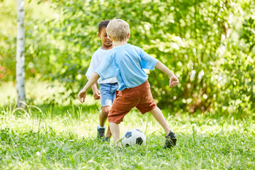 Two boys in a duel in football