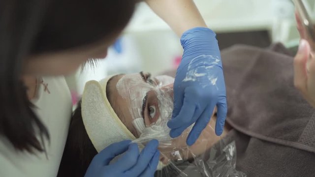Mesotherapy face pack being applied on patient for procedure, close up