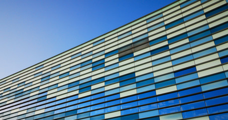 Fototapeta na wymiar Blue windows of a modern building against the sky