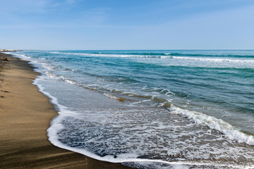 Beautiful sea and the black sandy beach, Tyrrhenian sea near Roma, Italy