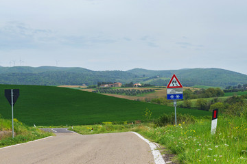 Fototapeta na wymiar Winding road in green hills Tuscany, Italy